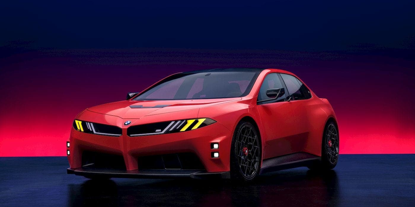 The M Concept Neue Klasse front-on — M Yellow Lights piercing the merged grille-and-headlight surface.