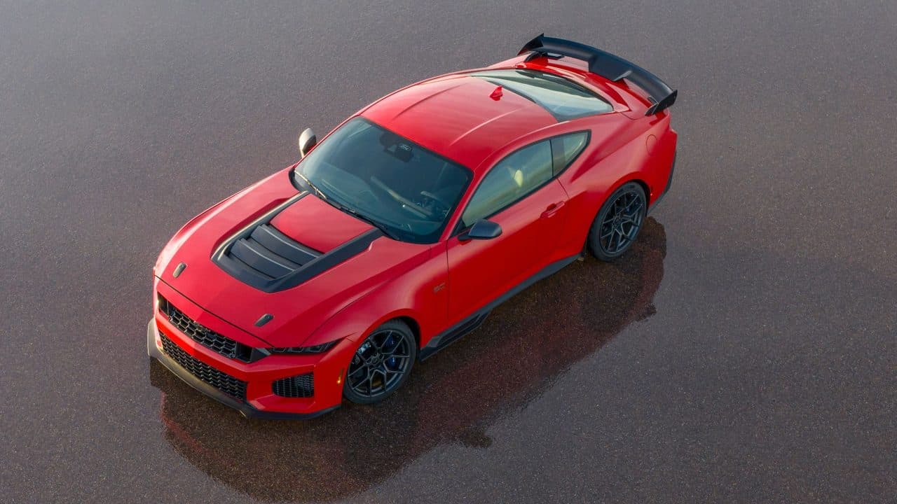 2026 Ford Mustang Dark Horse SC in Race Red, viewed from above showing the vented hood and carbon-fibre rear wing.