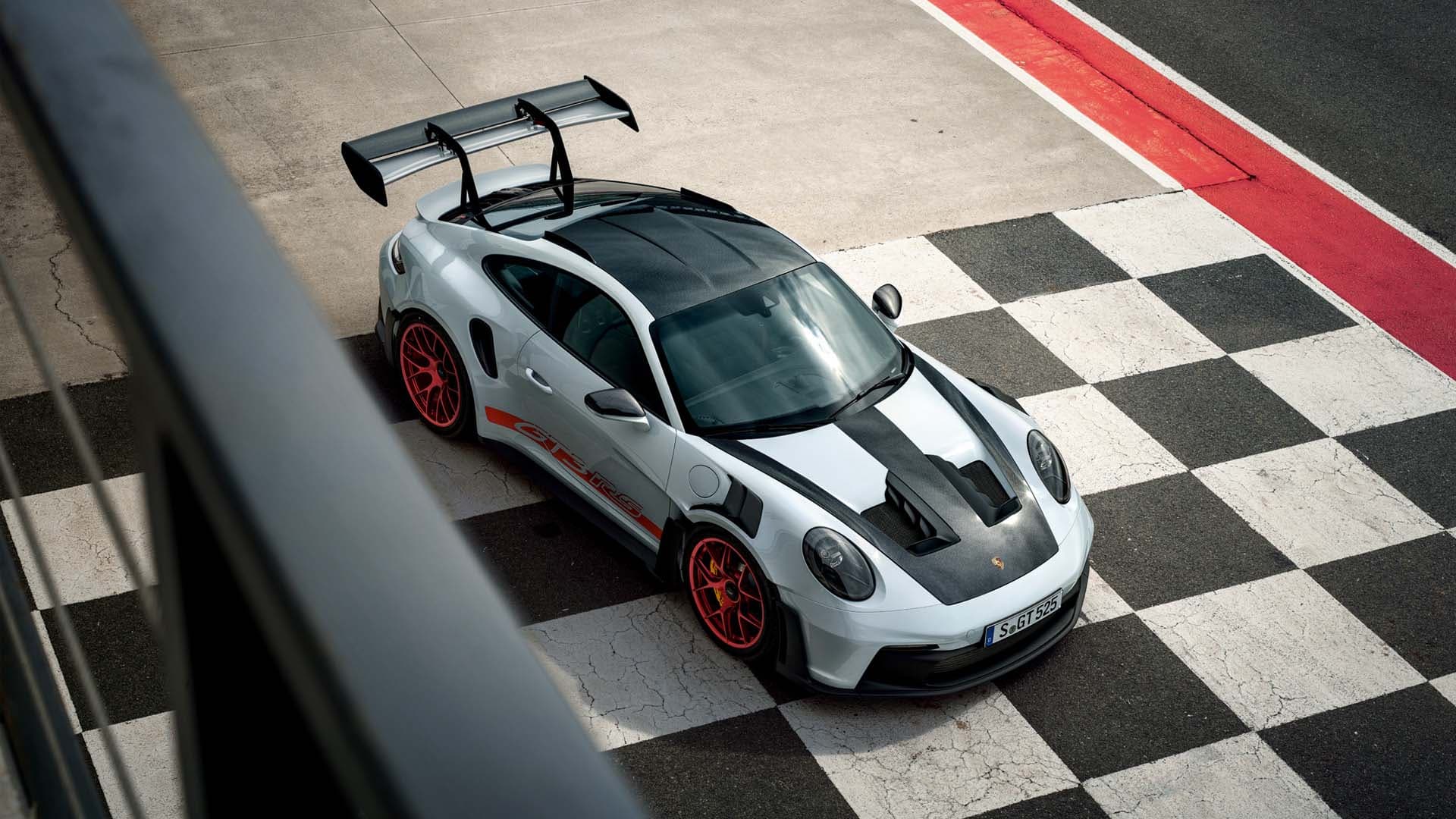992 GT3 RS from above on a racetrack kerb, showing the full aerodynamic package.